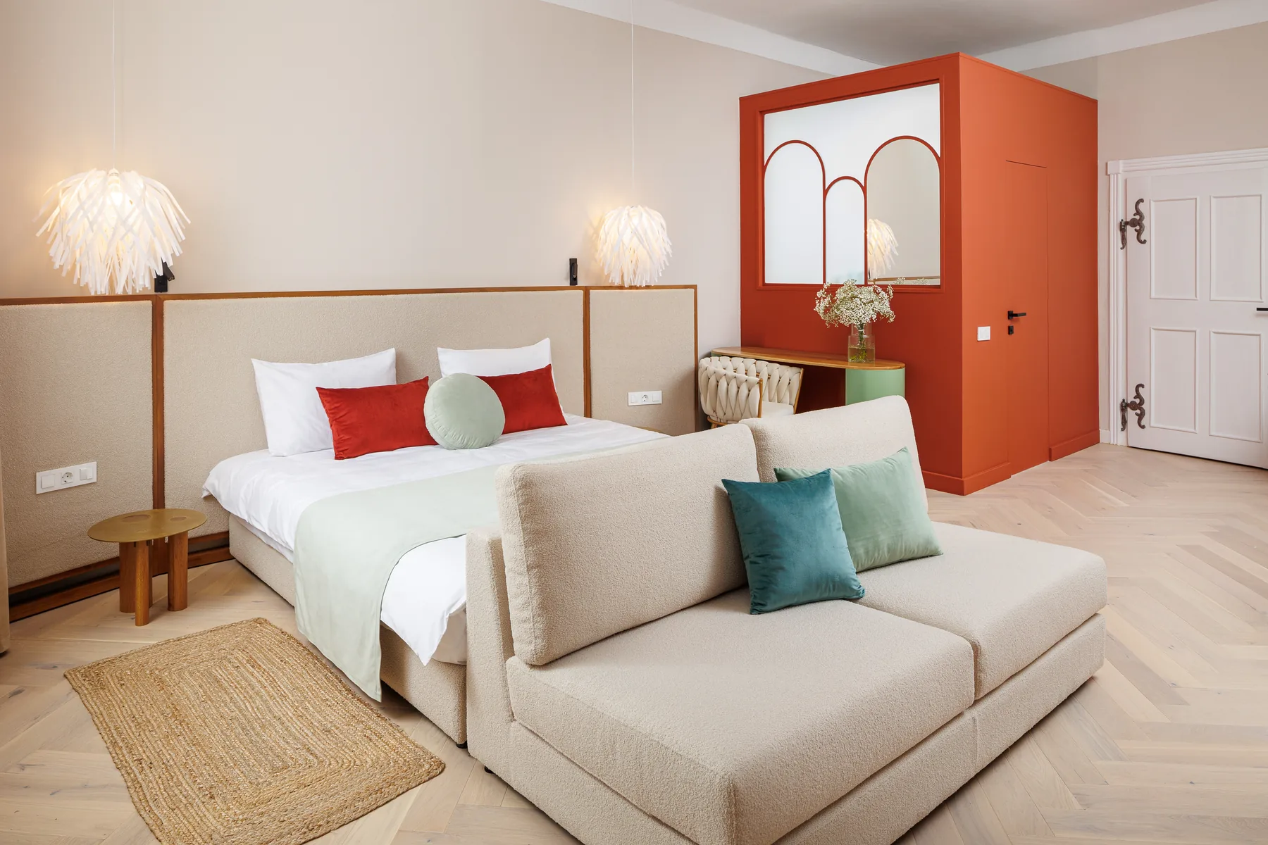 Aries’ Collection suite with a red partition and cream sofa